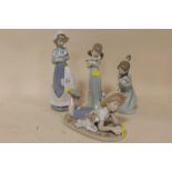 TWO LLADRO FIGURES OF GIRLS WITH CATS, TOGETHER WITH A NAO FIGURE OF A WOMAN WITH A PUPPY AND A
