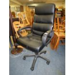 A MODERN BLACK SWIVEL OFFICE CHAIR