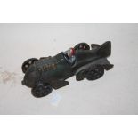 A CAST METAL MODEL OF A MAN IN A RACE CAR LENGTH - 16CM