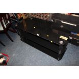 A MODERN BLACK GLASS TV STAND