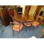 A LATE VICTORIAN MAHOGANY WIND-OUT DINING TABLE WITH TWO SPARE LEAVES RAISED ON FLUTED SUPPORTS WITH