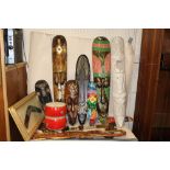 A COLLECTION OF TREEN TO INCLUDE TRIBAL STYLE MASKS, FRAMED AND GLAZED BOOMERANG, BONGO DRUMS ETC