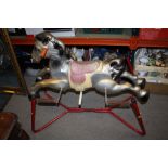 A TIN PLATE VINTAGE CHILD'S ROCKING HORSE ON STAND