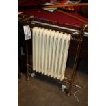 A DUEL FUEL CREAM AND GOLD RADIATOR AND TOWEL WARMER