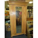 AN OLD PINE MIRRORED WARDROBE