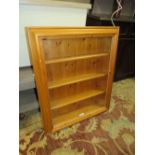 A MODERN HONEY PINE GLAZED WALL CABINET 63 X 75 CM