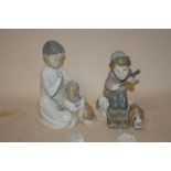 A LLADRO FIGURE OF A HUNTER BOY WITH DOG, TOGETHER WITH A LLADRO SEATED BOY AND DOG FIGURE (2)