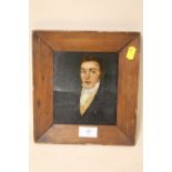 A SMALL PINE FRAMED OIL ON BOARD PORTRAIT STUDY OF A GENTLEMAN IN CLASSICAL DRESS A/F-BOARD SPLIT TO