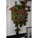 A CARVED WOODEN CUCKOO CLOCK