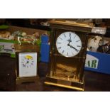 A BROOKS AND BOSTOCK QUARTZ CARRIAGE CLOCK WITH A EIGHT DAY BRASS AND GLASS CHIMING MANTEL CLOCK
