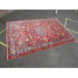 AN EASTERN WOOLLEN RUG MAINLY RED / PINK GROUND 235 X 156 CM