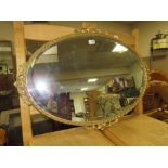 A GILT OVAL WALL MIRROR W-86 CM