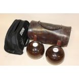 A PAIR OF LAWN BOWLS TOGETHER WITH A LEATHER CARRY BAG