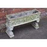 A RECTANGULAR GARDEN PLANTER WITH FLORAL DETAIL ON RAISED FEET