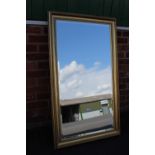 A LARGE CONTEMPORARY GILT FRAMED WALL MIRROR 75 X 128 CM