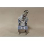 A LLADRO FIGURE OF A YOUNG GIRL STANDING ON AN ARM CHAIR WITH KITTENS MARKED 1998 EVENT FIGURINE