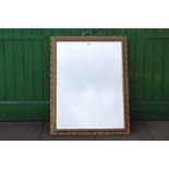 A LARGE GILT FRAMED BEVEL EDGE WALL MIRROR, OVERALL SIZE INCLUDING FRAME 89 X 105 CM