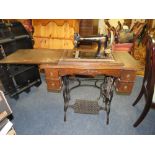 A VINTAGE OAK TREADLE SEWING MACHINE WITH 'THE AVENUE' AMERICAN MADE MACHINE