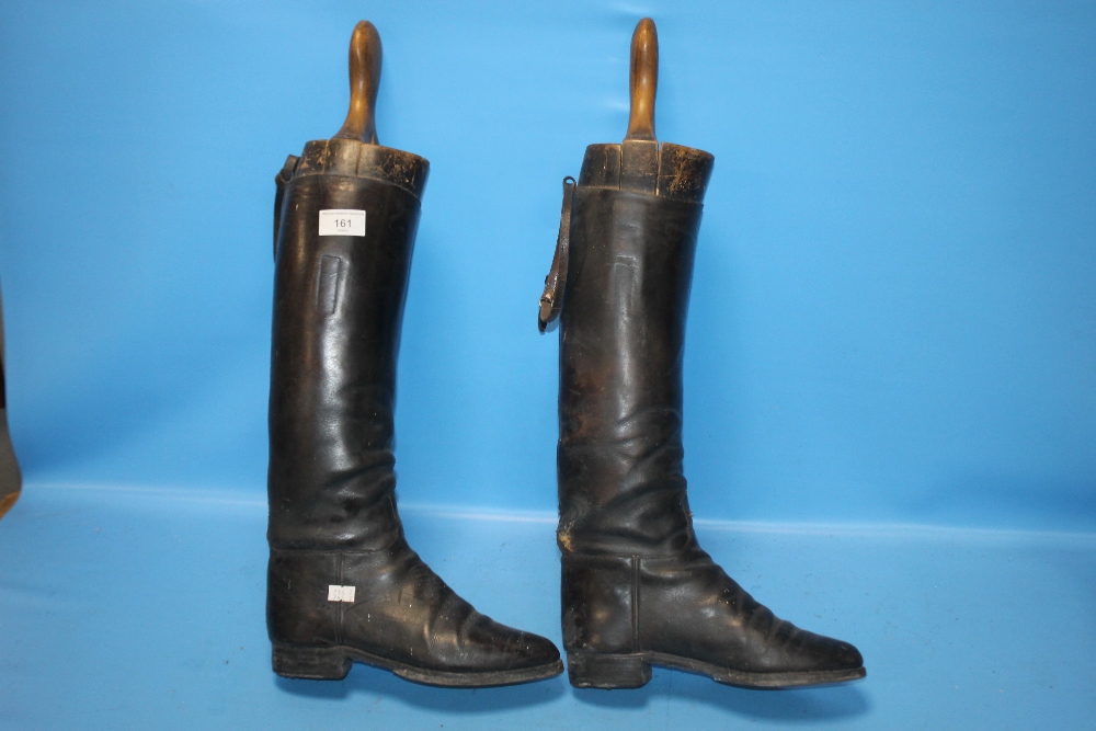 A PAIR OF LEATHER RIDING BOOTS AND STRETCHERS