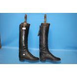 A PAIR OF LEATHER RIDING BOOTS AND STRETCHERS
