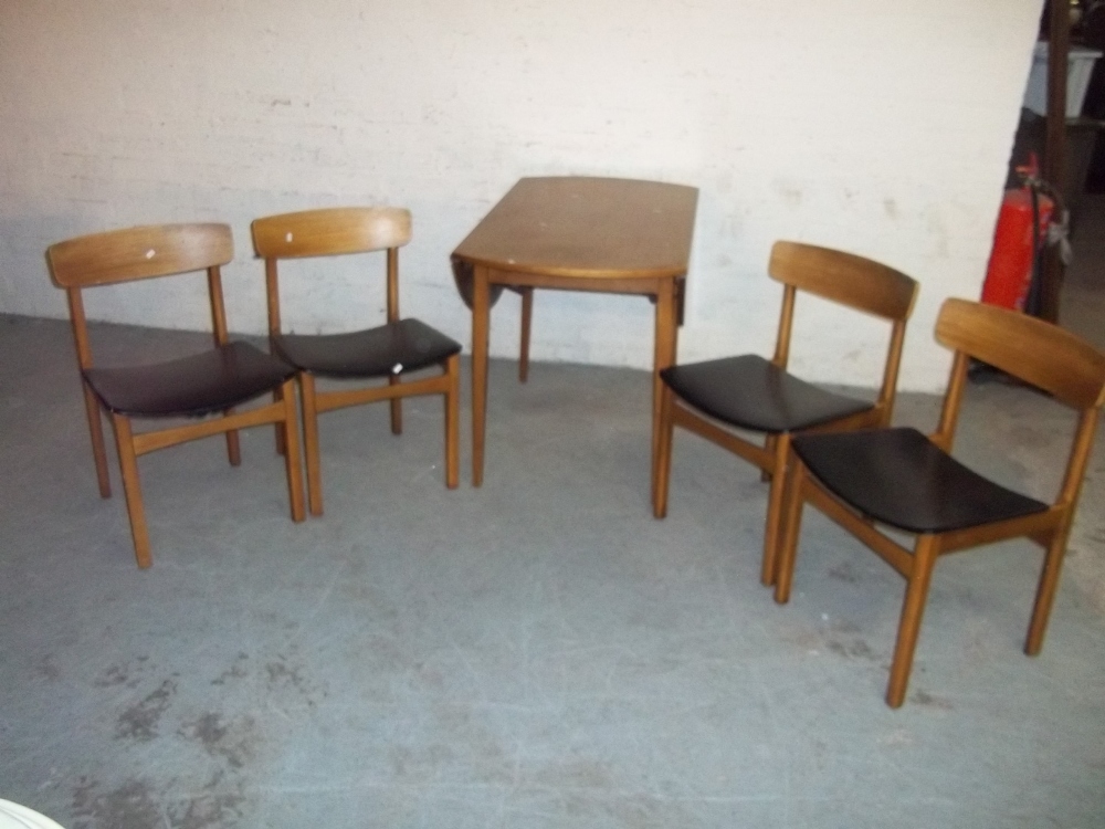 A TEAK CIRCULAR DROP LEAF DINING TABLE AND FOUR CHAIRS