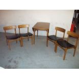 A TEAK CIRCULAR DROP LEAF DINING TABLE AND FOUR CHAIRS