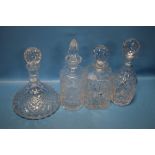 FOUR ASSORTED CUT GLASS DECANTERS