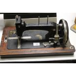 A VINTAGE CASED SEWING MACHINE