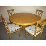 A ROUND DINING TABLE WITH FOUR CHAIRS