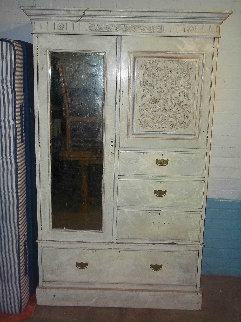 A PAINTED WARDROBE WITH CARVED DETAIL