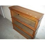 A WERNICKE STYLE SECTIONAL BOOKCASE BY A. M. Y. L. (WITH CRACKED GLASS)