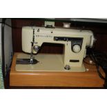 A CASED BROTHER SEWING MACHINE AND A COLLECTION OF ASSORTED SEWING ACCESSORIES