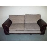 A THREE SEATER FABRIC / FAUX LEATHER SOFA