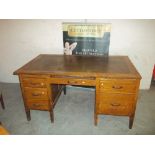 AN OAK ANTIQUE TWIN PEDESTAL DESK