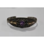 A VINTAGE STERLING SILVER AND AMETHYST BANGLE WITH FLORAL DETAIL APPROX WEIGHT - 21.1G