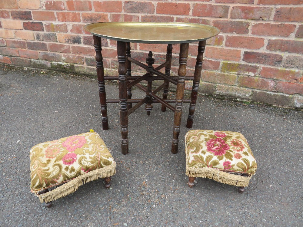 AN EASTERN BRASS TOPPED TABLE ON FOLDING STAND WITH TWO SMALL STOOLS (3)