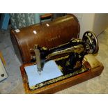 A CASED VINTAGE SINGER SEWING MACHINE