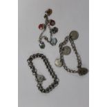 THREE SILVER BRACELETS TO INCLUDE A CHARM BRACELET, COIN BRACELET ETC. APPROX WEIGHT - 48.1G