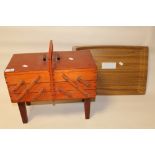 A WOODEN FOLD OUT SEWING BOX TOGETHER WITH A WOODEN SERVING TRAY
