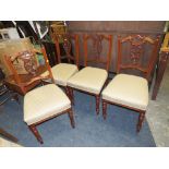 A SET OF FOUR EDWARDIAN CARVED MAHOGANY DINING CHAIRS
