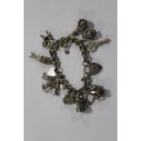 A LARGE HALLMARKED SILVER CHARM BRACELET APPROX WEIGHT 70.8G