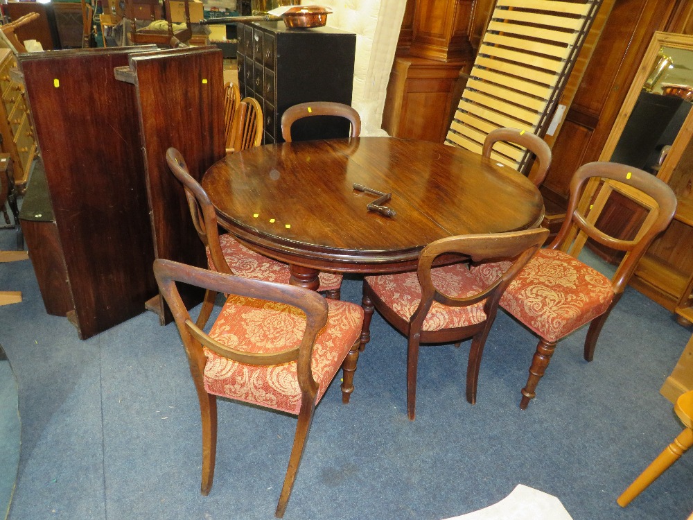 A LATE VICTORIAN MAHOGANY WIND-OUT DINING TABLE WITH TWO SPARE LEAVES RAISED ON FLUTED SUPPORTS - - Image 3 of 3