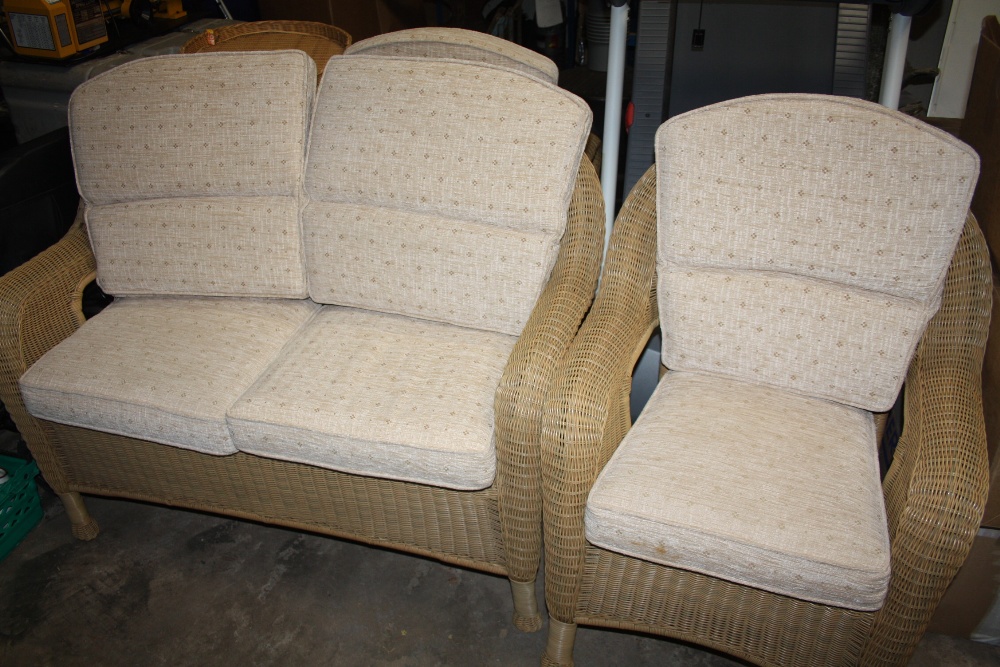 A WICKER CONSERVATORY SUITE COMPRISING OF A TWO SEATER AND A PAIR OF ARM CHAIRS (3)