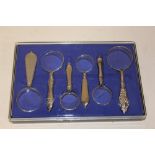 A CASED SET OF SIX MAGNIFYING GLASSES