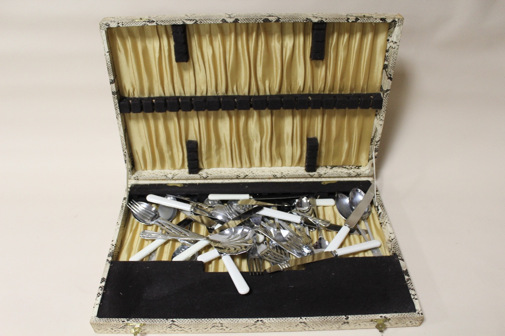 A SNAKESKIN EFFECT CANTEEN OF STAINLESS STEEL CUTLERY