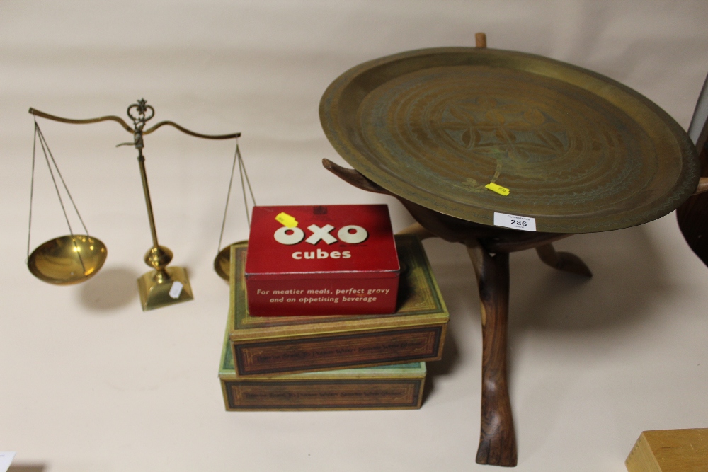 A BRASS TOPPED TRIPOD TABLE WITH A SET OF BRASS SCALES AND THREE TINS