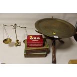 A BRASS TOPPED TRIPOD TABLE WITH A SET OF BRASS SCALES AND THREE TINS