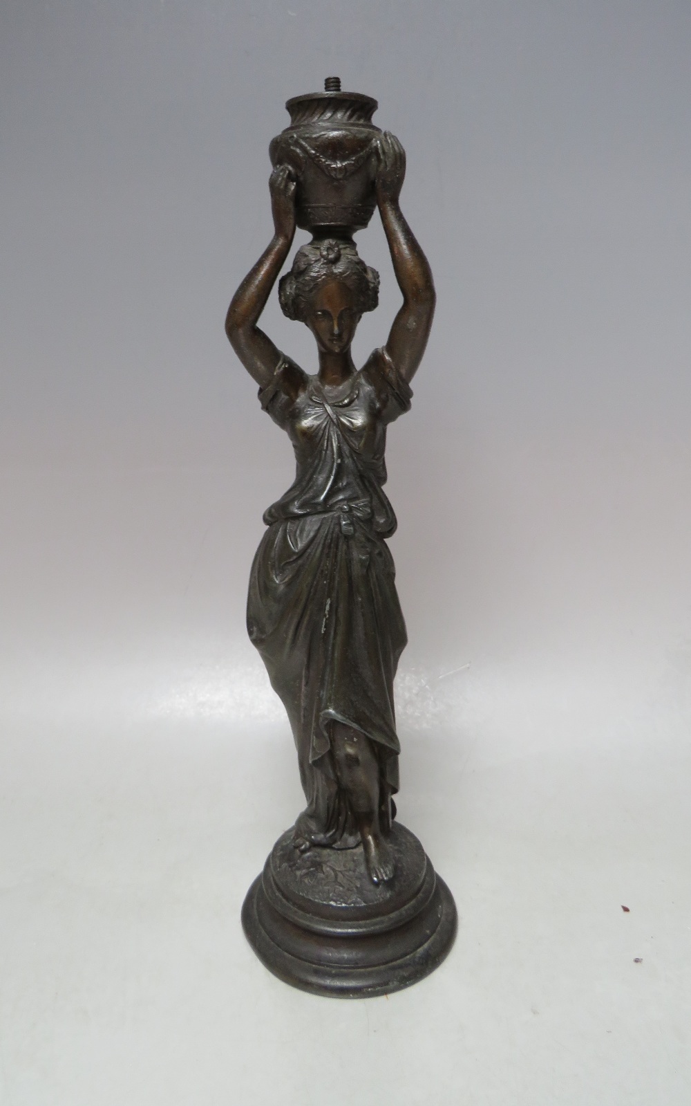 A VINTAGE BRONZE BAR GAS LIGHTER, in the form of a young woman in classical dress carrying an urn, H