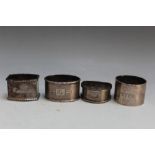 FOUR ASSORTED HALLMARKED SILVER NAPKIN RINGS TO INCLUDE A SCOTTISH EXAMPLE BY WAKELY & WHEELER -