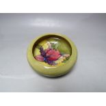 A MOORCROFT CIRCULAR DISH OF SMALL PROPORTIONS, impressed marks under glaze to base, approx Dia..